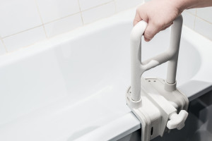 hand holding the handrail in the bathroom